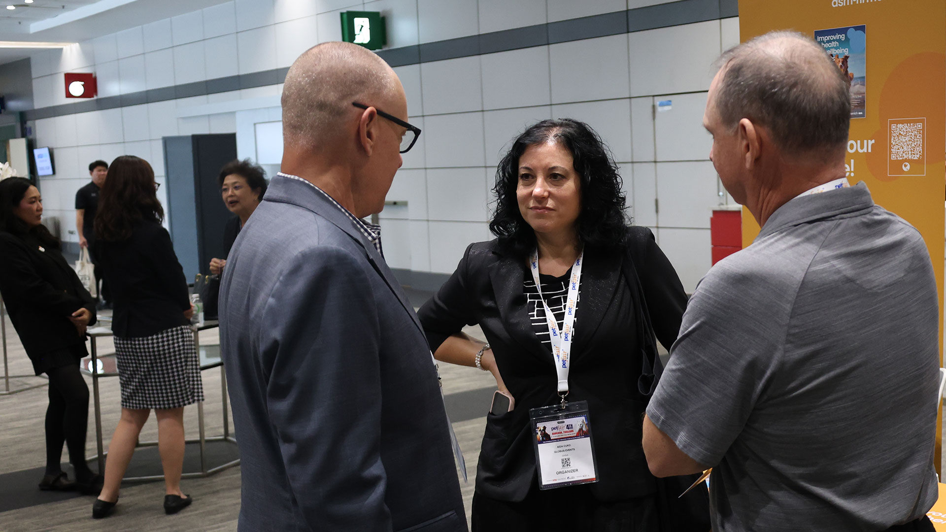 Two men and a lady talking at Petfood Forum Asia