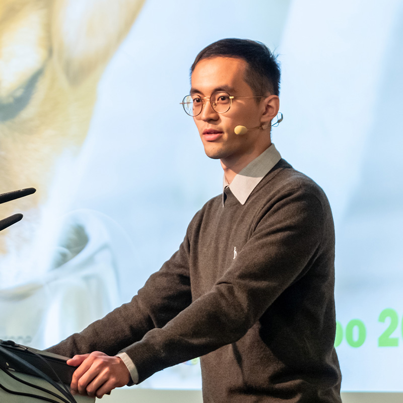 Male speaker presenting behind a podium at Petfood Forum Europe