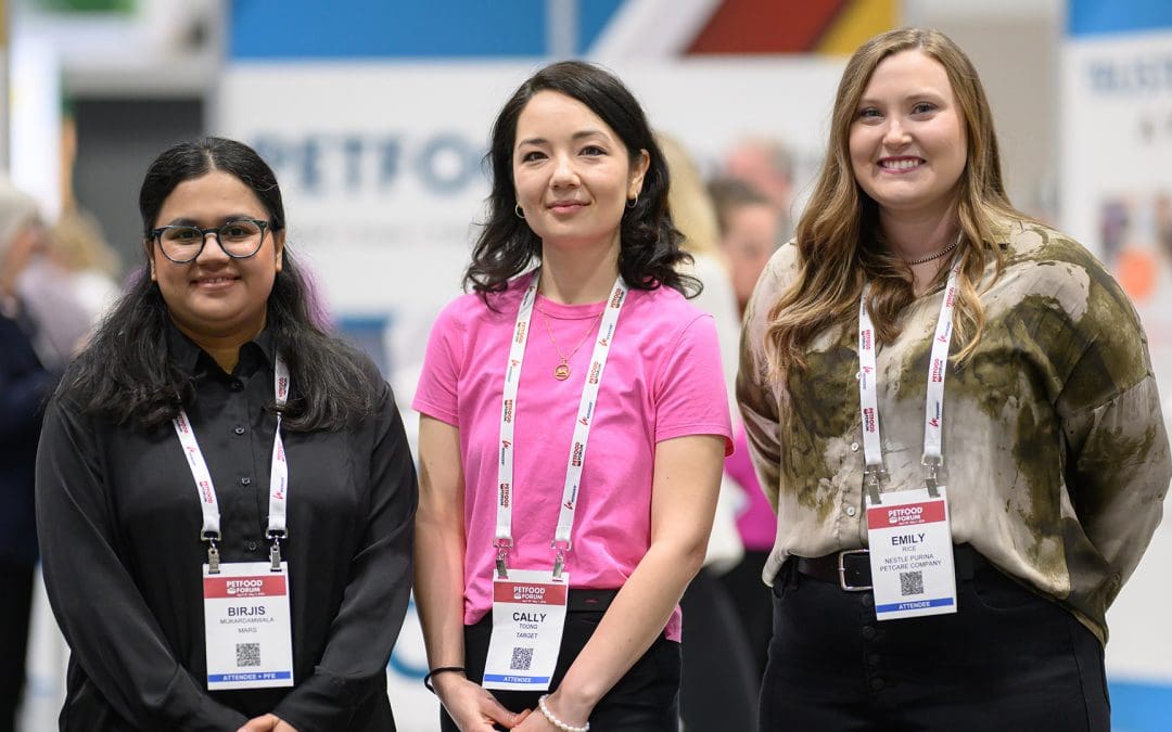 Three women pose for the camera at Petfood Forum