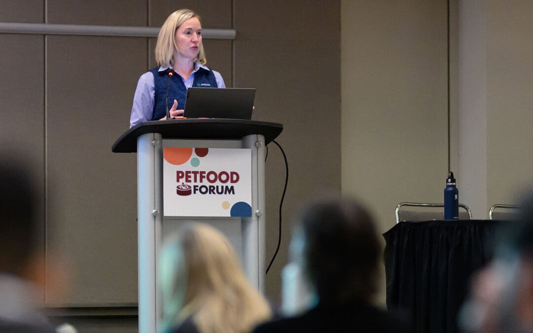 Female speaker from IFEEDER standing at podium speaking at Petfood Forum