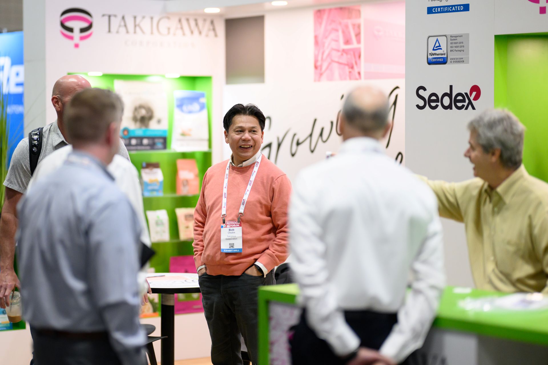 Men networking and smiling in Petfood Forum booth