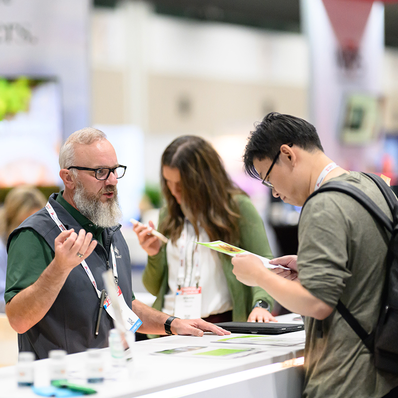 Professionals discussing in booth at Petfood Forum