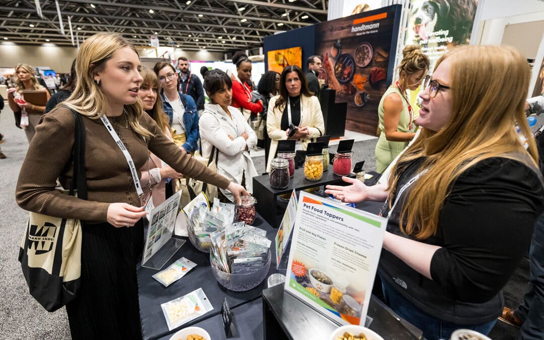 Women speaking in booth at Petfood Forum 2026