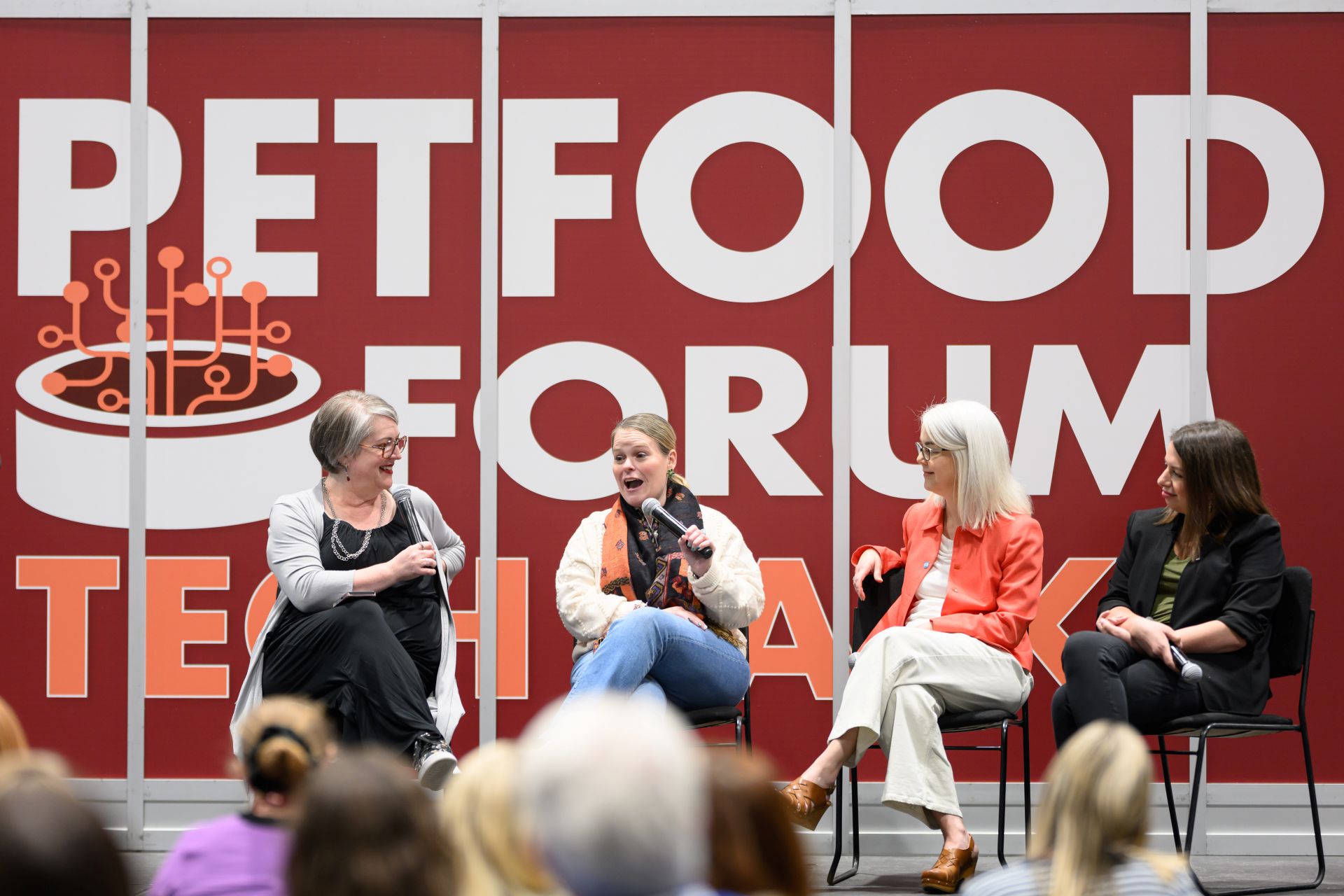 Four female panelists speaking on stage at Petfood Forum