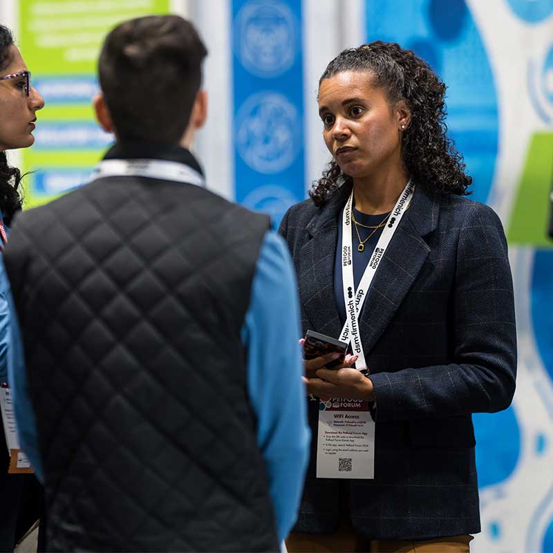 A man and women are standing and having a conversation at Petfood Forum